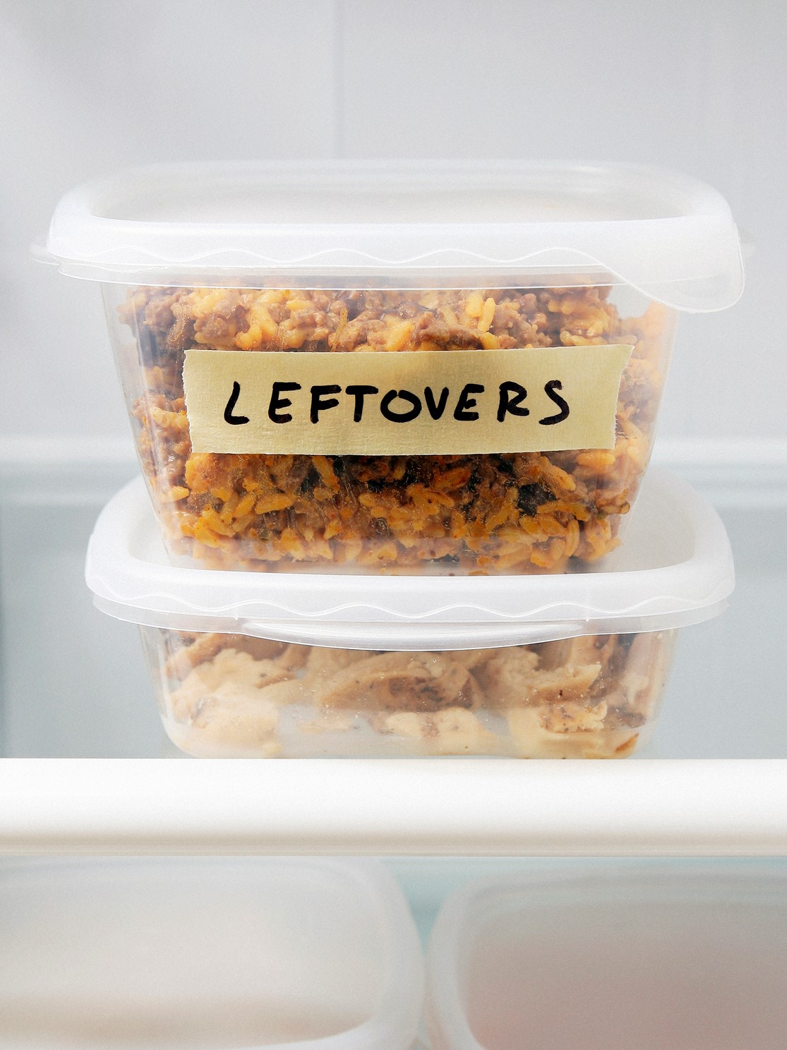 Tupperware container in fridge labeled "leftovers"