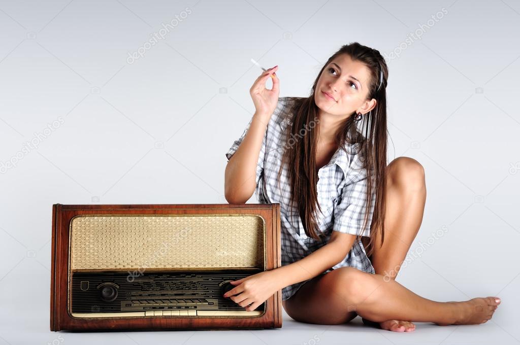 Woman listening to music on the radio isolated on white background